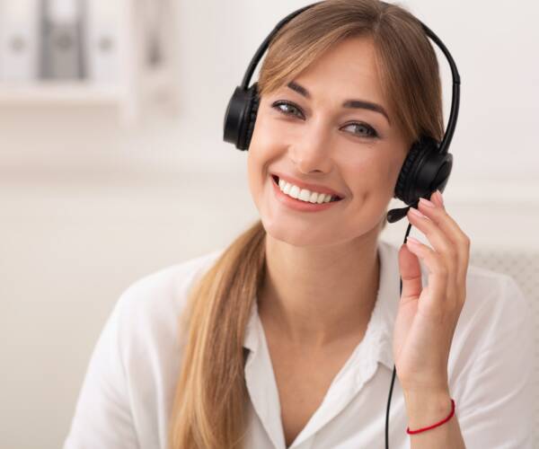 Smiling Woman In Headset Working In Call Center Office Smiling Woman In Headset Working In Call Center Office