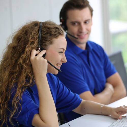 Smiling Woman In Headset Working In Call Center Office